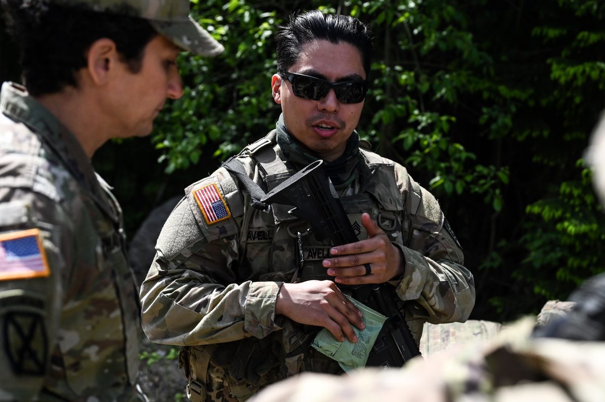 Benjamin Avellaneda speaking with soldiers during field training